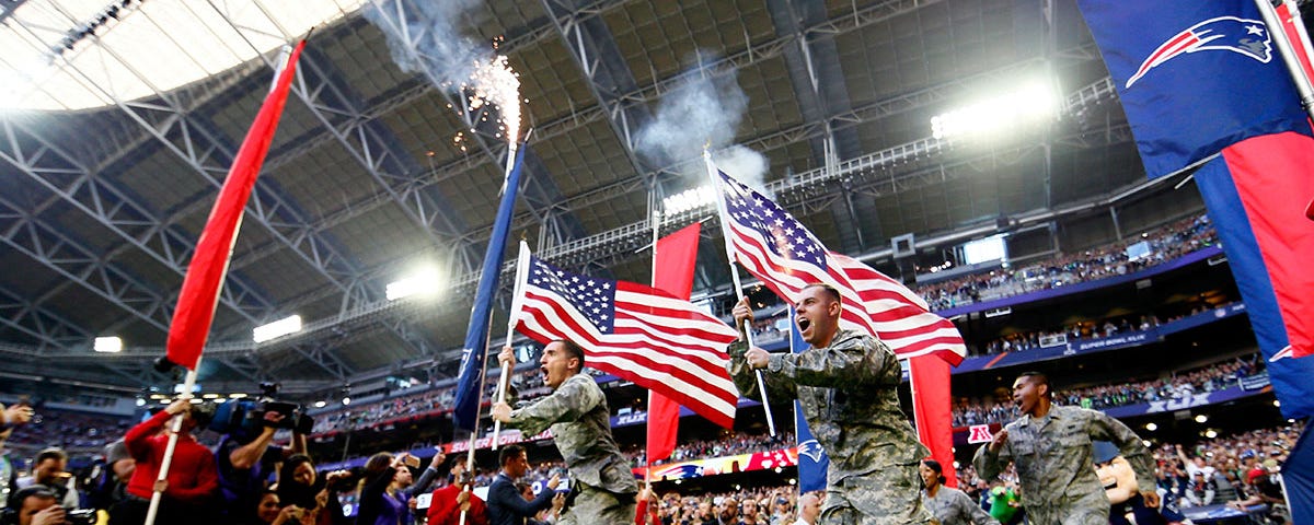 Members of the United States military run onto the field prior to Super Bowl XLIX between the Seattle and New England.