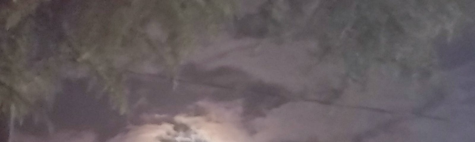 Full moon cloaked by clouds