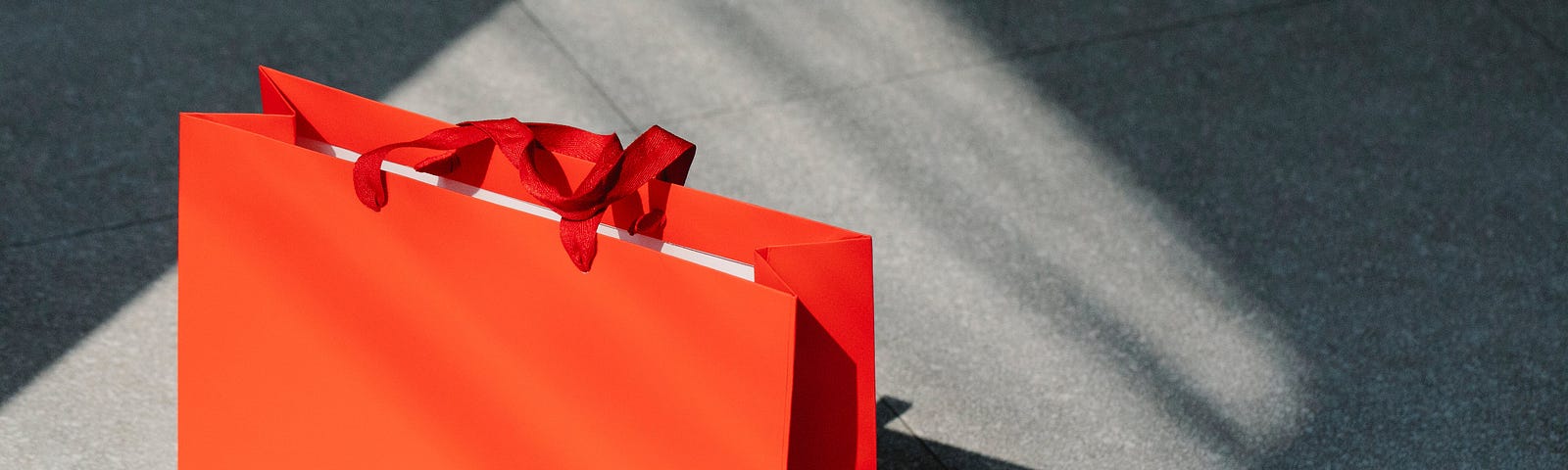 This is a photo of a red paper shopping bag.