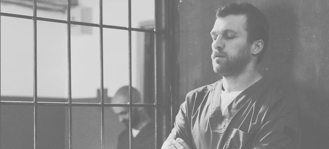 man standing in prison cell