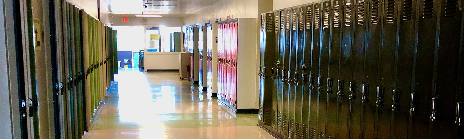 A high school classroom hallway with no students, just lockers lining the walls