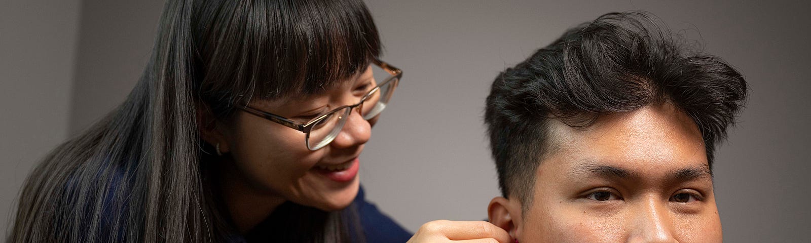 Anh Nguyen adjusts equipment for a research subject.