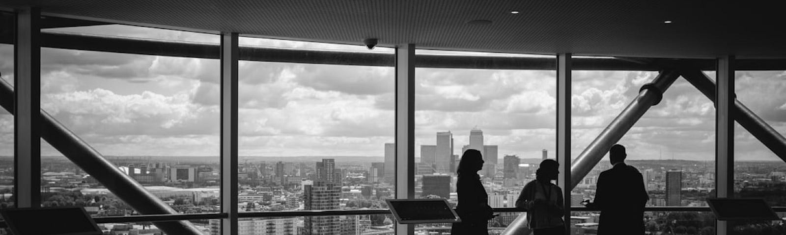 Figures by the window of a large office