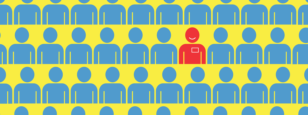 one red cartoon person with a smiley face is sitting in a crowd of blue faceless people