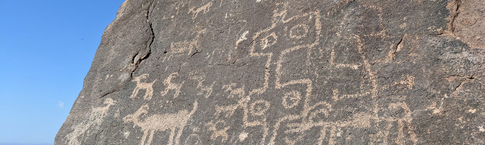 Petroglyphs of what appear to be animals carved into rock