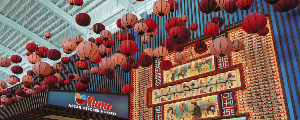 Picture of a Japanese restaurant in an airport with lanterns suspending in the air.