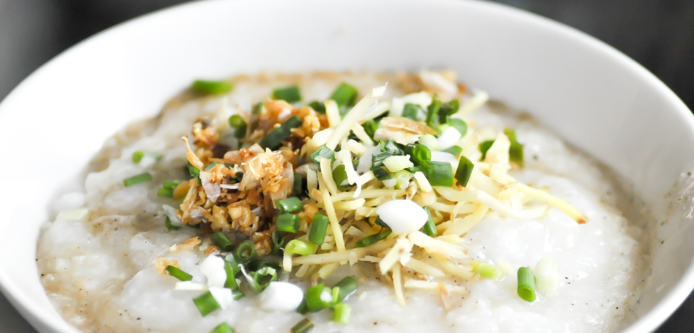 white bowl with rice porridge and garnish. Jook: The Astounding Korean Rice Porridge For An Upset Stomach by Nancy Blackman. health, korea, korean food, jook