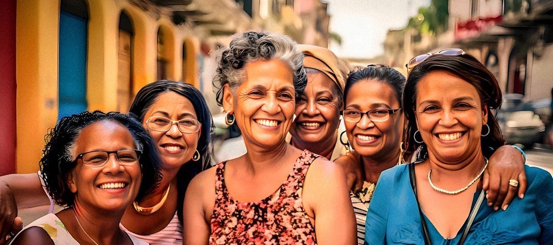 A group of joyful Caribbean women smiling broadly, embracing each other on a bustling street, embodying the spirit and strength of their culture.