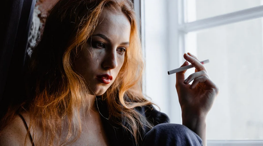 close-up-photo-of-distressed-woman-smoking-cigarette