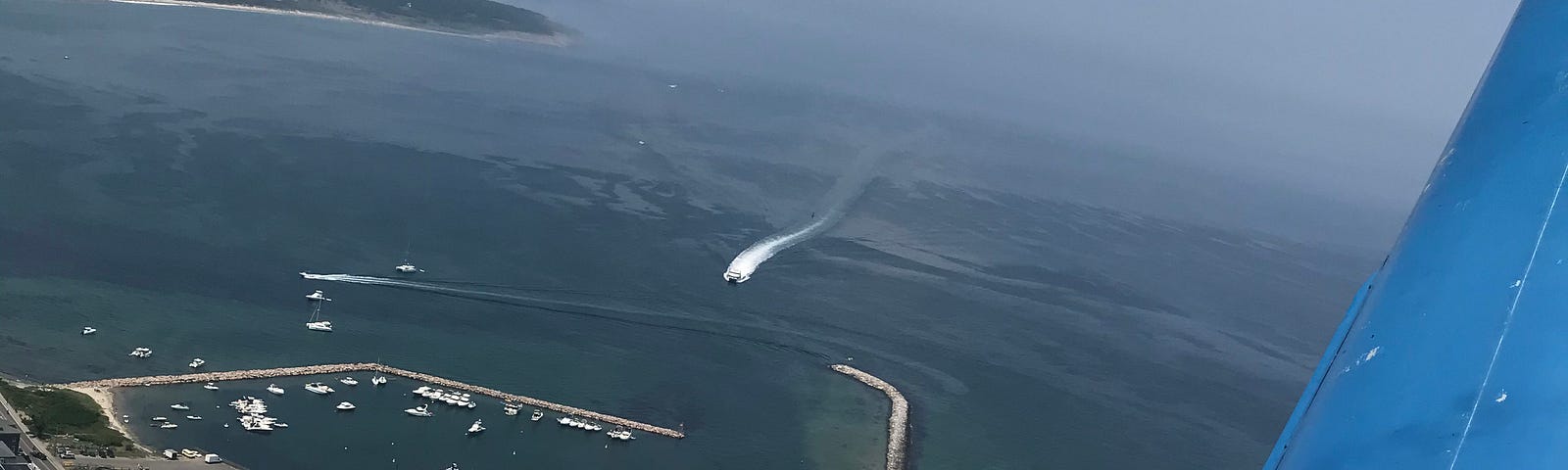 A strip of beach as seen out the window of an aircraft.