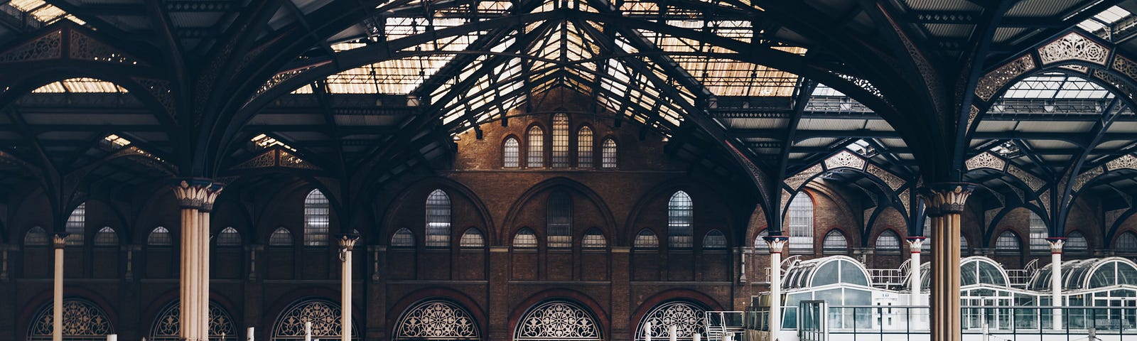 A train station with people waiting to board trains