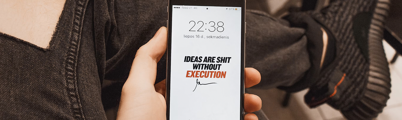 person holding iPhone Ideas Are Shit Without Execution