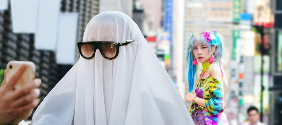 Man with a sheet over his head taking selfie