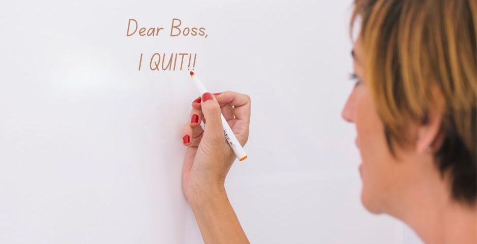 A woman writing on a white board the words “Dear Boss, I Quit!”