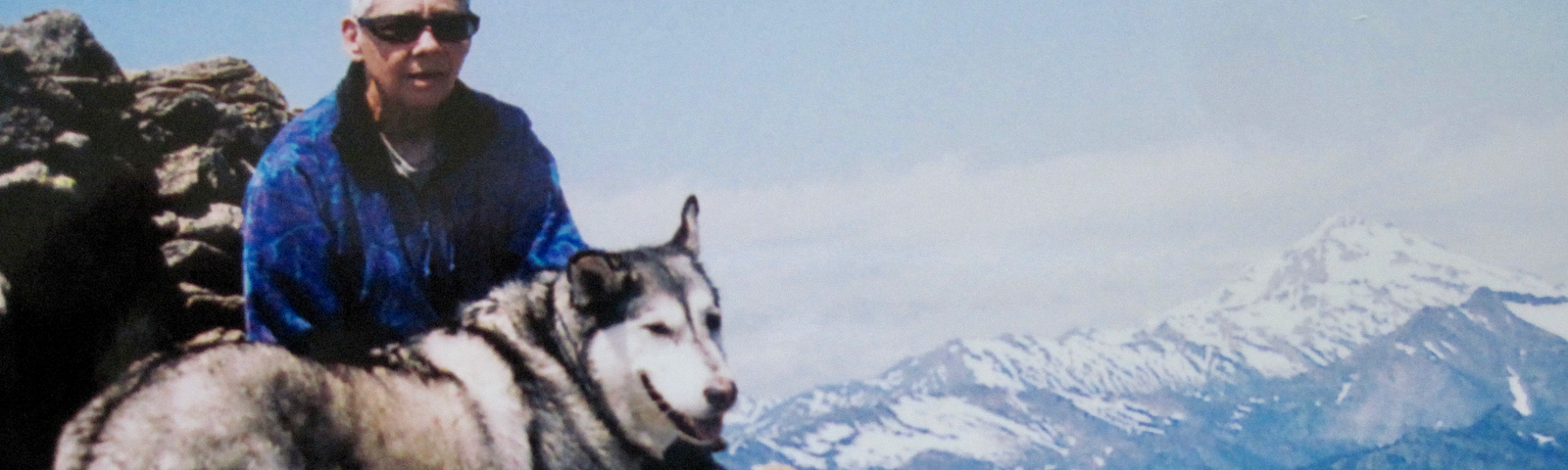 Photo of author with husky on a high point after a forast walk.