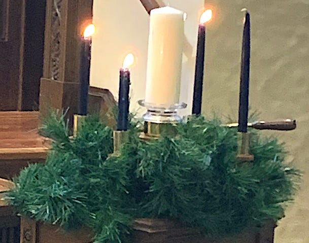 An Advent wreath with three candles lit