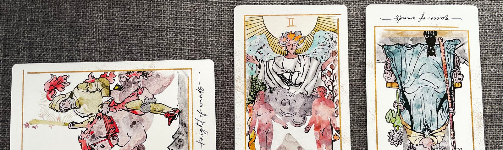 3 Tarot cards laid out from left to right: Knight of Wands (sideways), Lovers, Queen of Wands (reversed). The illustrations are based on traditional Tarot card design, but recreated in watercolor.