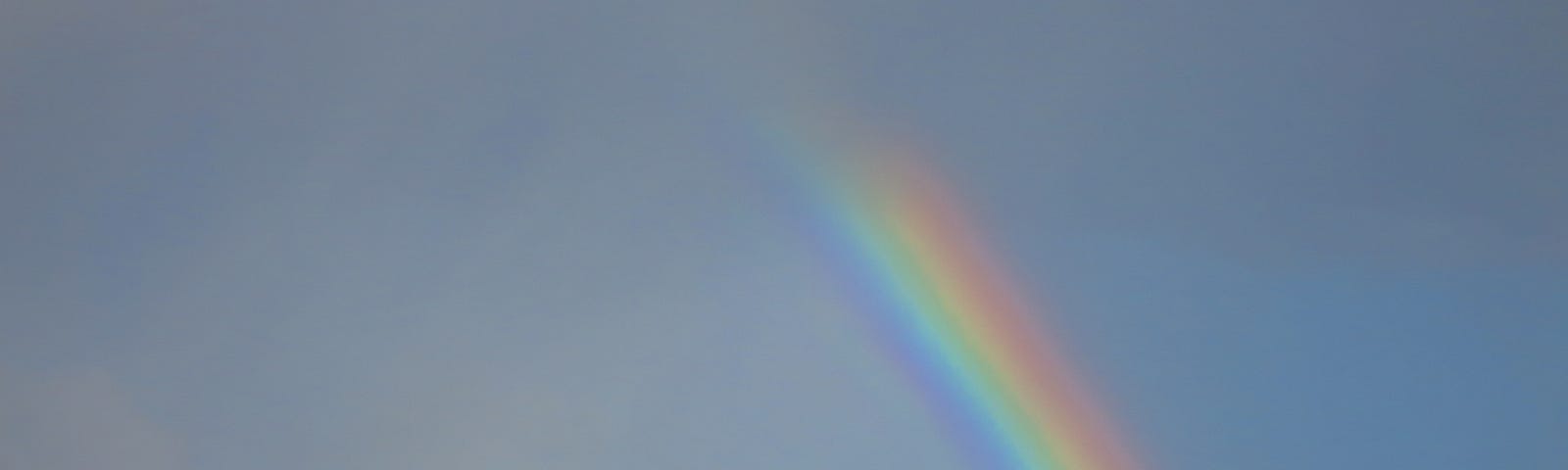 Rainbow above an ocean wave. Reminder of God’s promises and goodness.