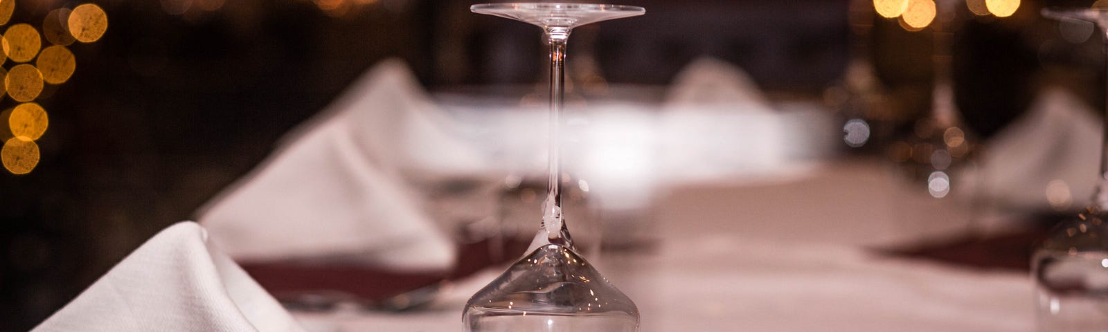 An empty wine glass turned upside down on a table