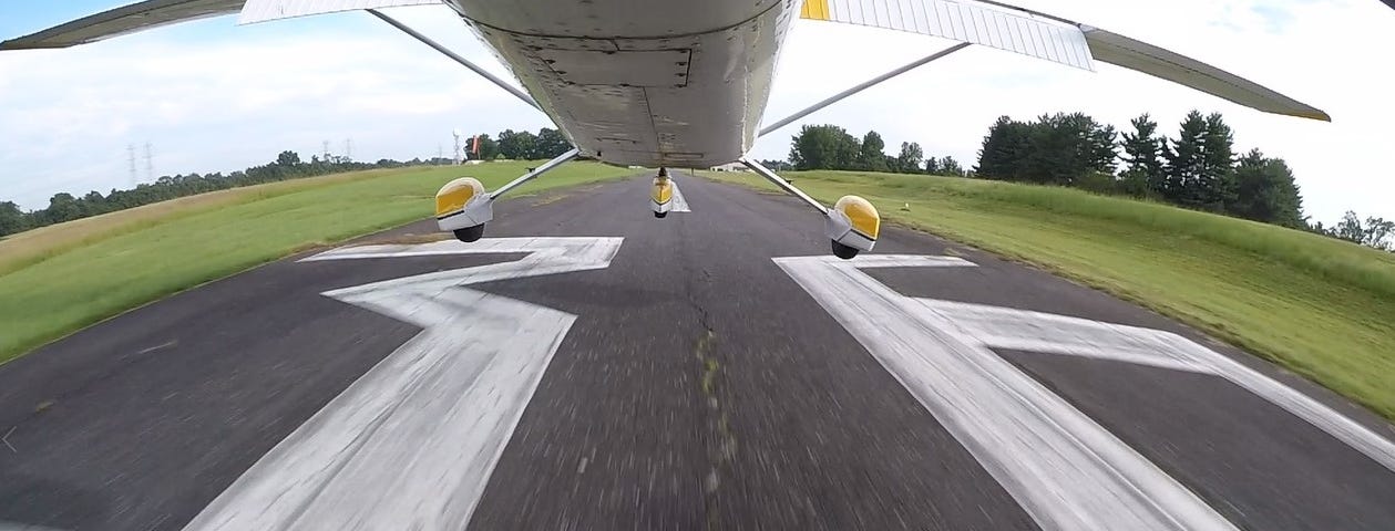 The undercarriage of a plan mid-landing.