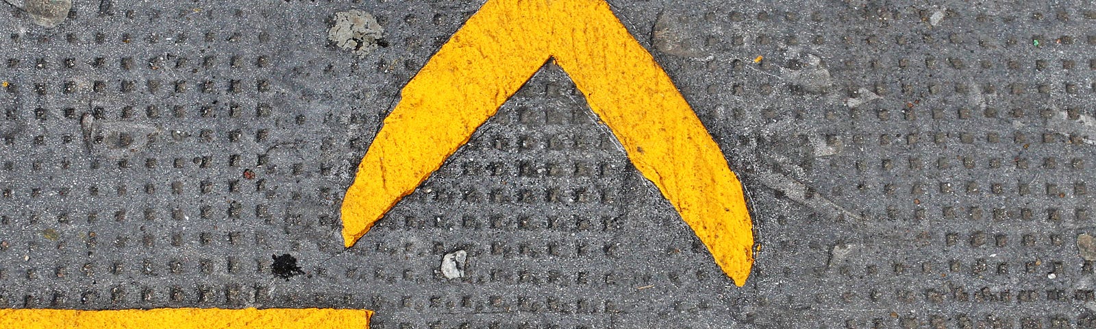 Bright yellow street lines with image of scissors and dotted line.