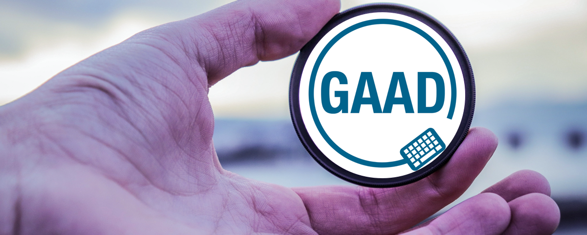 Man holding a lens, with the Global Accessibility Awareness Day logo added.