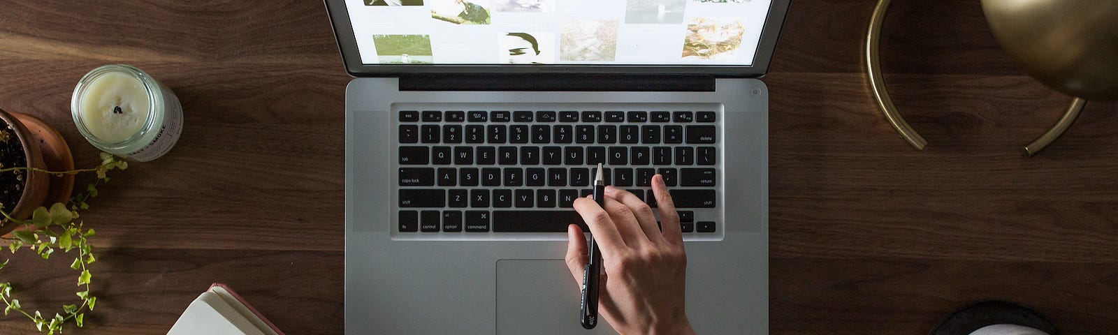 Person reviewing website with pen and notebook.