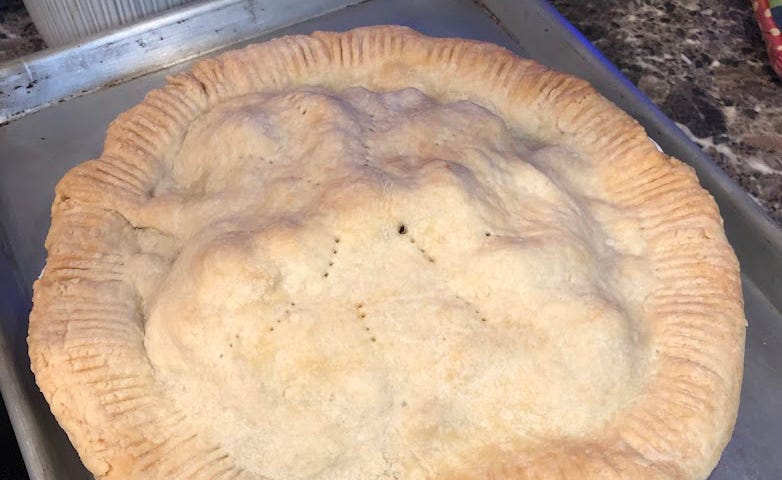 Home made apple pie cooling on a baking sheet