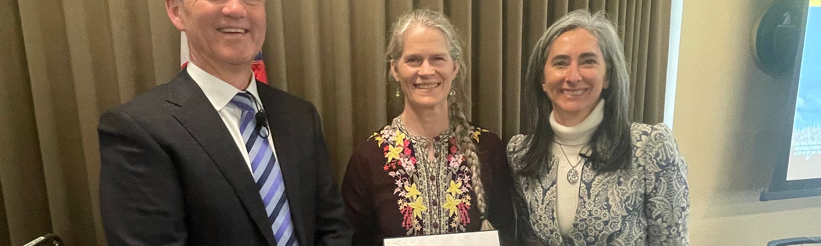 Sarah Hall (center) receives the Meritorious Service Award with Pacific Region Deputy Regional Director Bridget Fahey (right) and Regional Director Hugh Morrison (left).