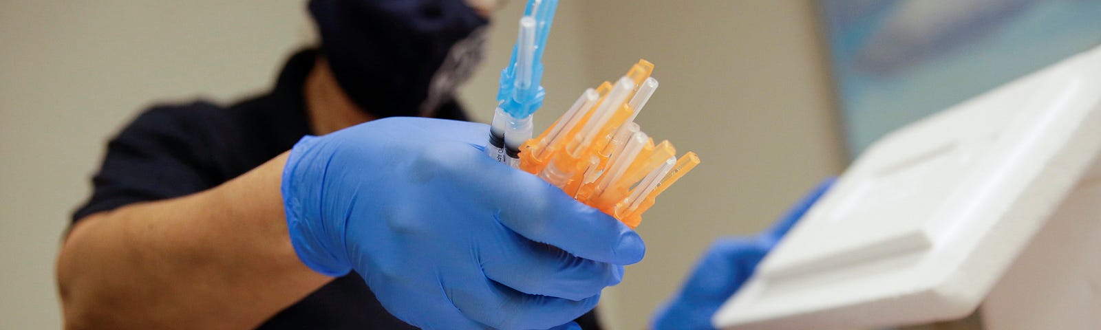 A healthcare worker holds syringes with COVID-19 vaccines at a vaccination center, in El Paso, Texas, May 6, 2021. Photo by Jose Luis Gonzalez/Reuters