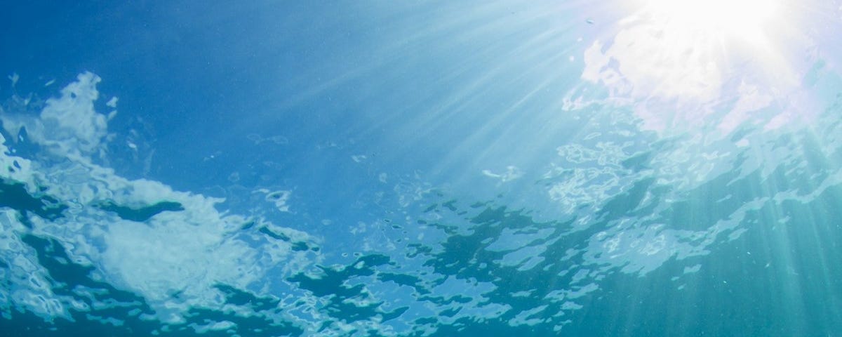 Sun blazing onto water, photo shot from under the surface