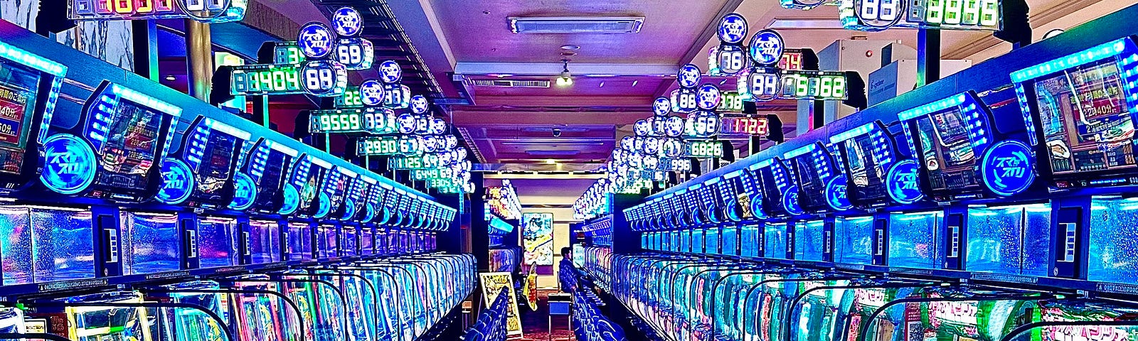 Image of several Japanese slot machines in a row.