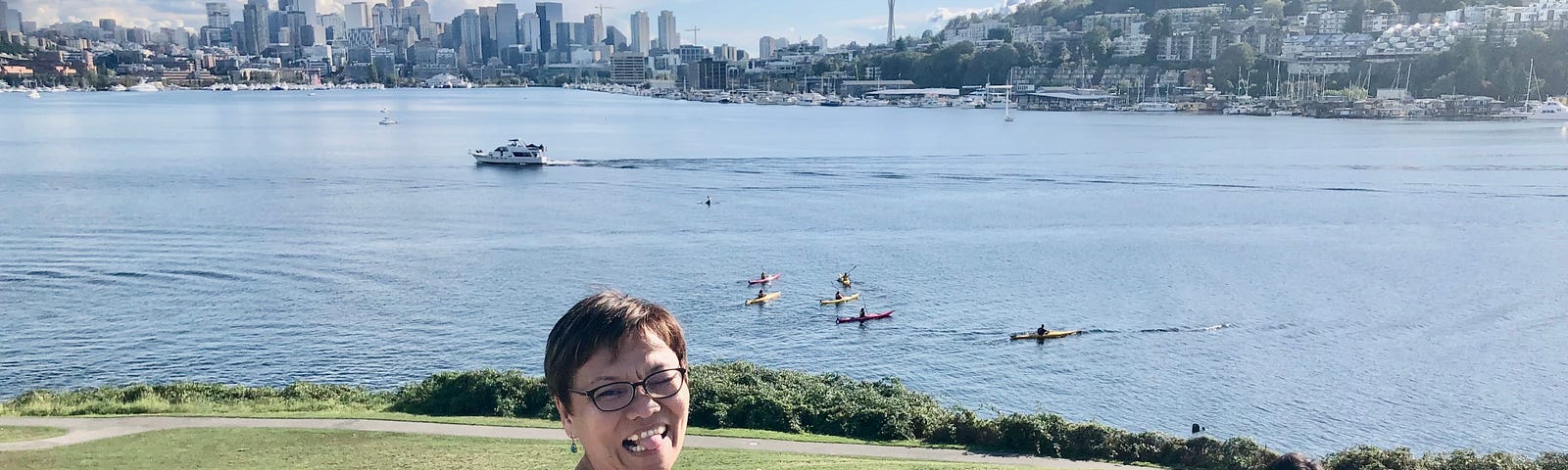 Mai smiling at the camera with the city of Seattle at the background