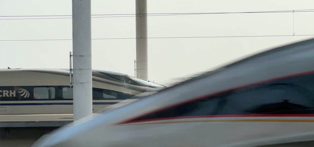 A picture of two High Speed trains at Baoding East railway station