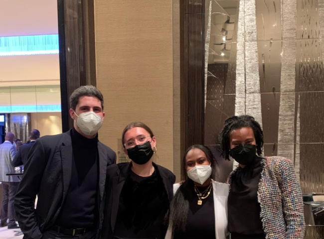 Georgetown University students Matthew Carvalho, Abigail Corrao, and Iman Ibrahim meet with Assistant Secretary for Global Affairs Loyce Pace at the World Health Assembly in Geneva.