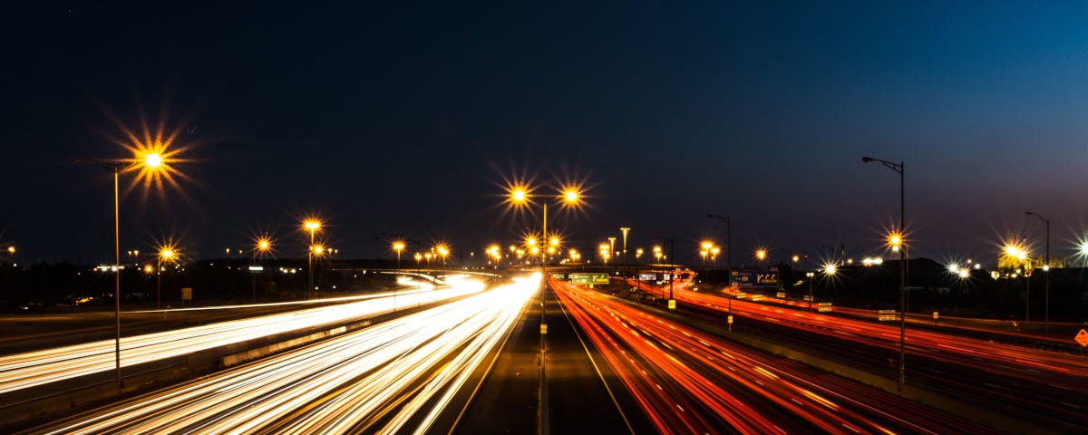 Night shot of the Interstate with trails from car lights.