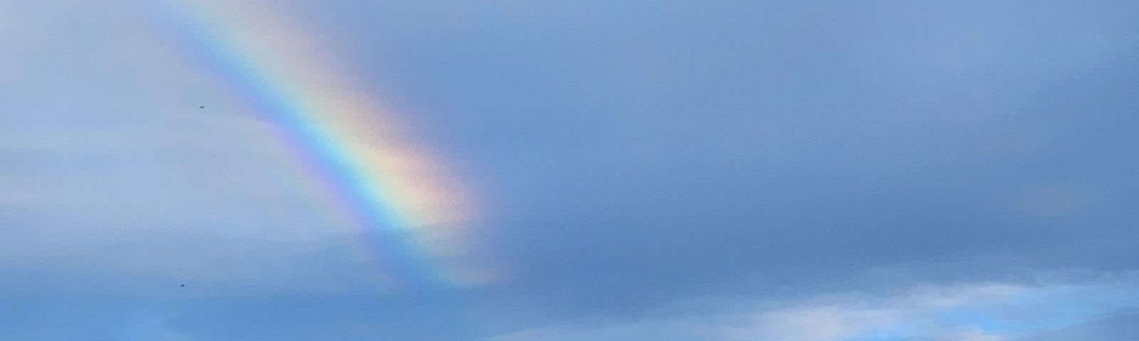 A rainbow in the blue sky