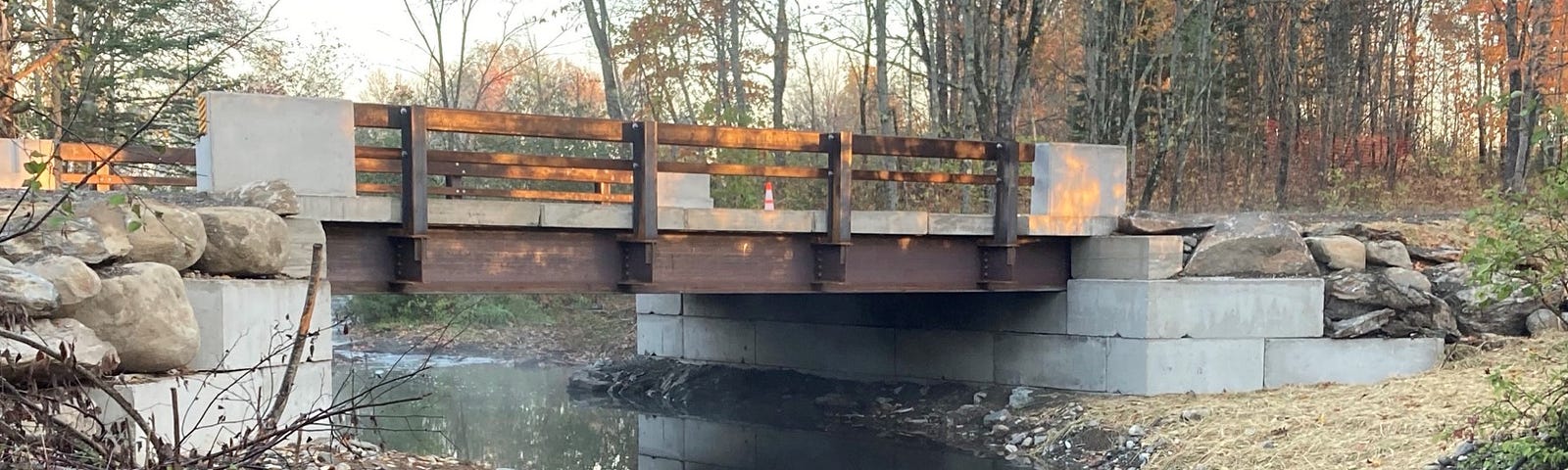 A bridge spans a stream with wide banks on each side