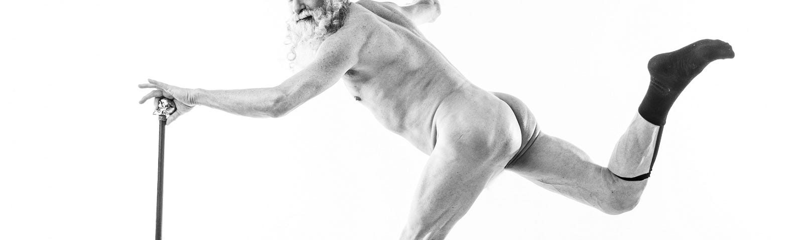 Naked man dancing with a cane and garters