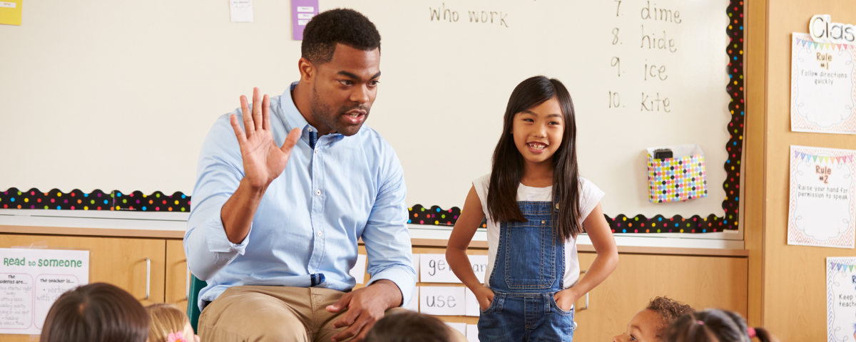 Teacher and students in a classroom.