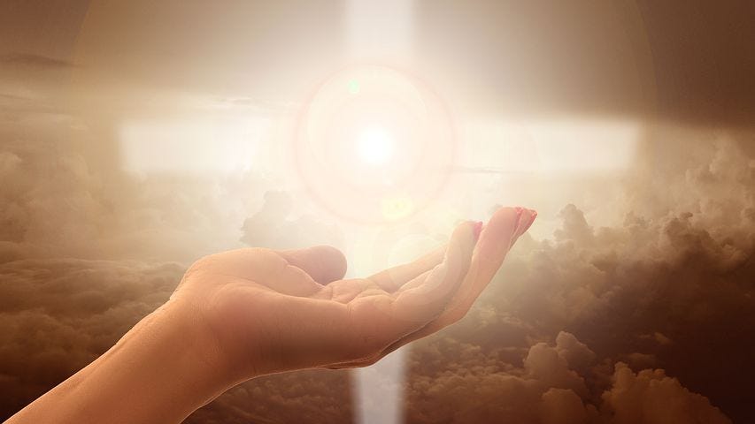 A bright soul light hovering over a person’s hand