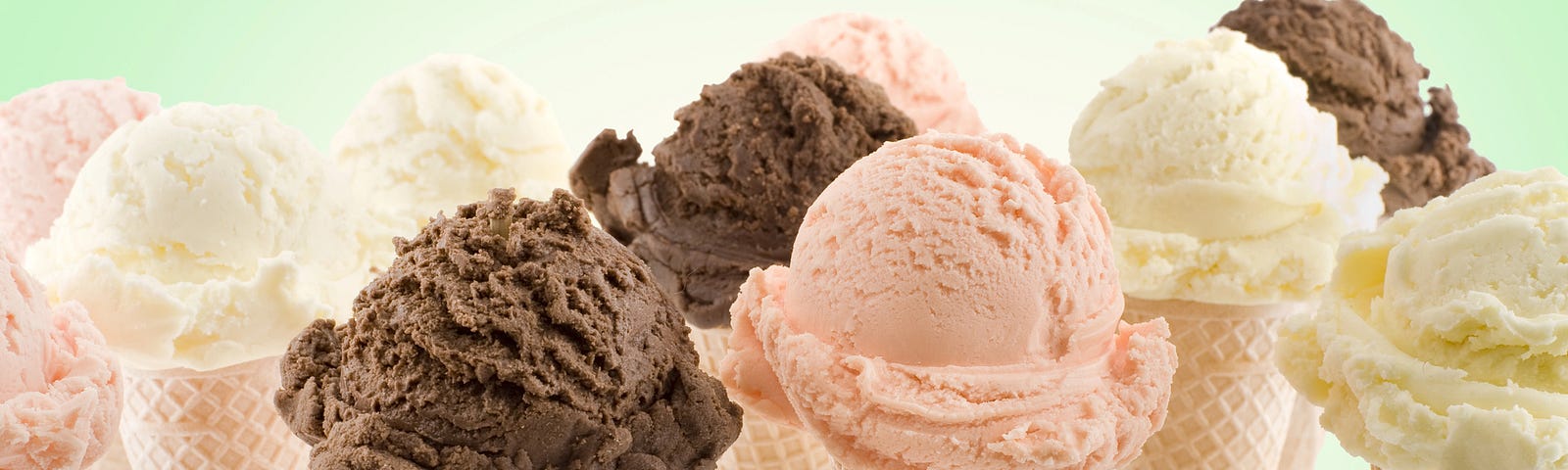 several ice cream cones against pale green background