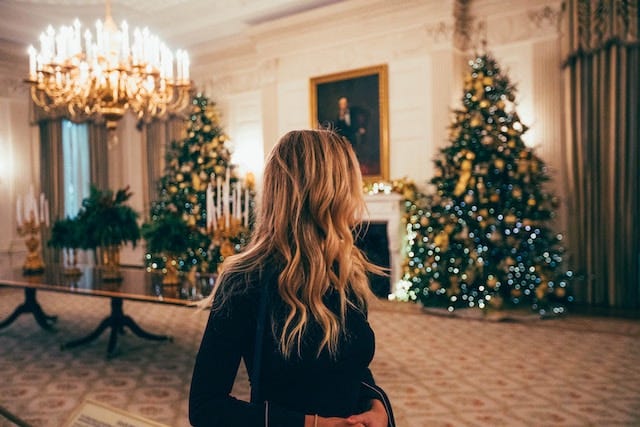 Woman surveying a room of amazing Christmas decorations she slaved over all month