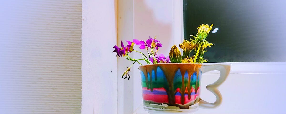 A painted mug full of flowers.