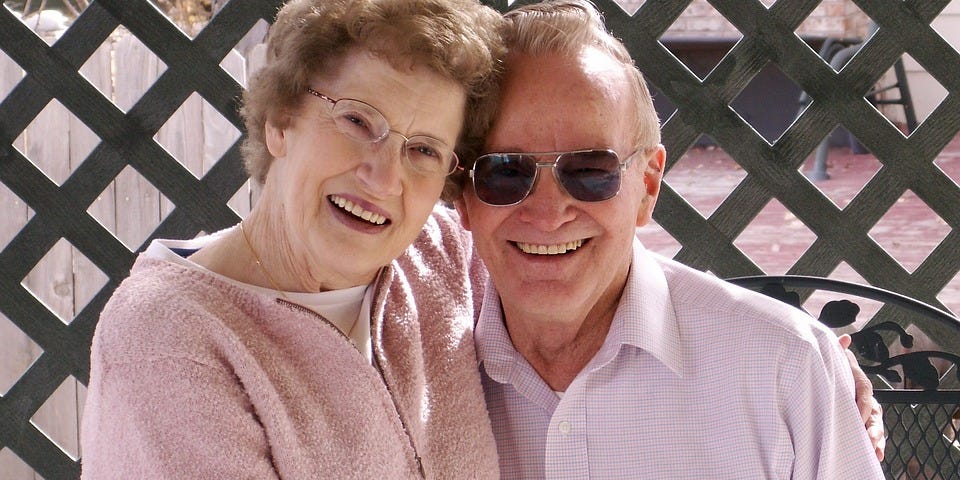 An elderly couple smiling in happiness.