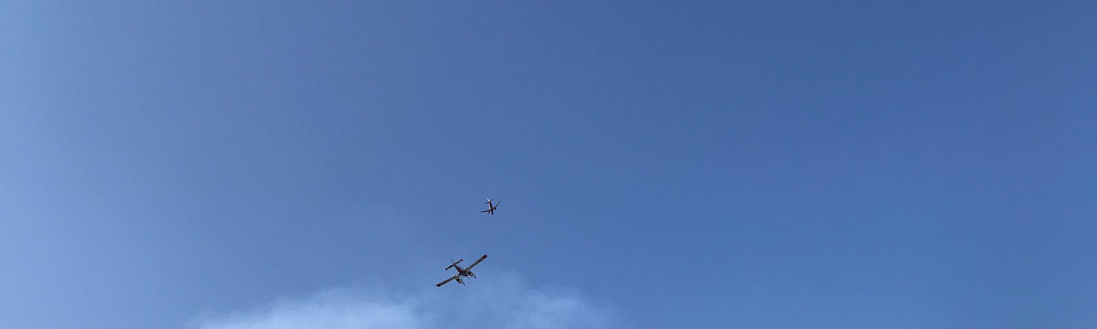 Forest Fire Command (above float plane) directing float planes where to drop water. Fire had just reached the ridge four miles from our home. Within an hour, the flames were under control on the ridge.