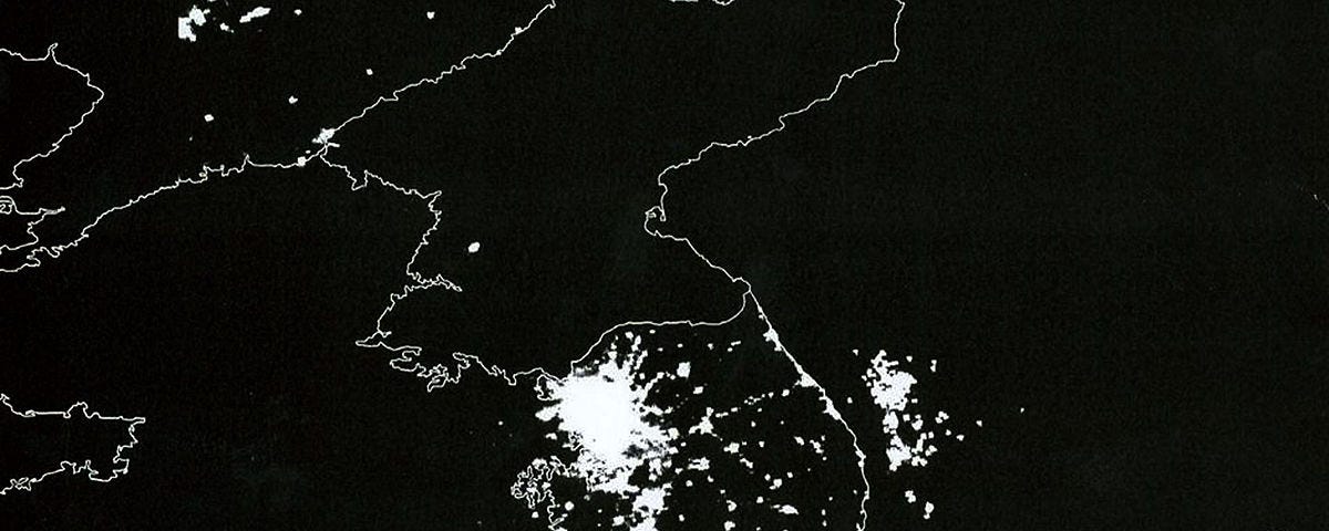 Korean Peninsula at night. South Korea is filled with lights and energy and vitality and a booming economy; North Korea is dark.