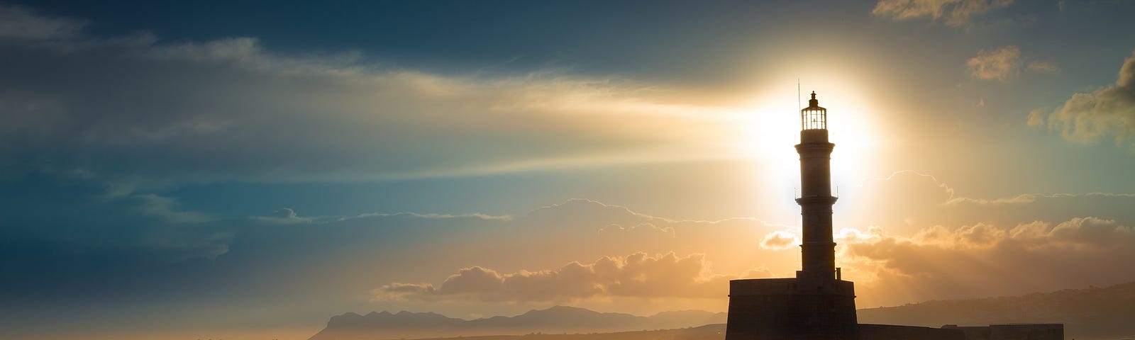 A beautiful night sky behind a shining lighthouse.