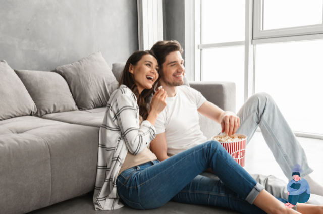 Two couples who are watching Netflix and eating popcorns.