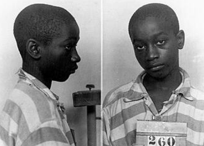 Historic mugshot of George Stinney Jr., the youngest person executed in the US, highlighting racial injustice and legal reform needs in a black-and-white photo.